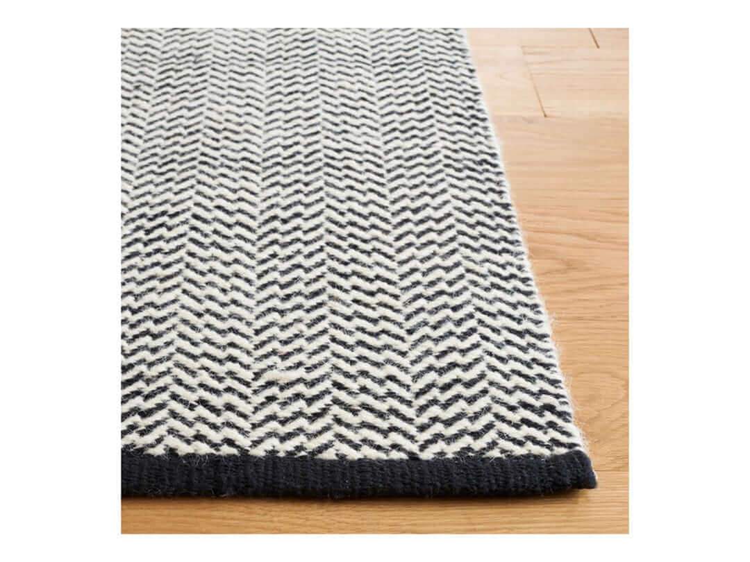 Black and white chevron style area rug, 8x10 size, perfect for enhancing any room with modern flair.
